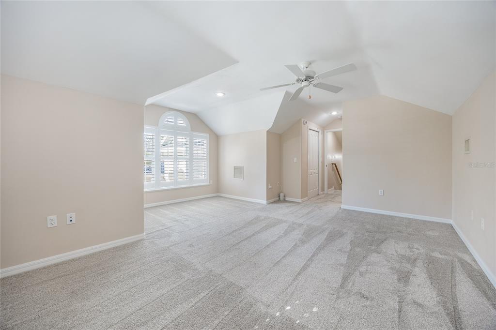 7146 Southwest 35th Avenue Gainesville, FL 32608 - Photo 61 of 83 an empty room with windows and ceiling fan