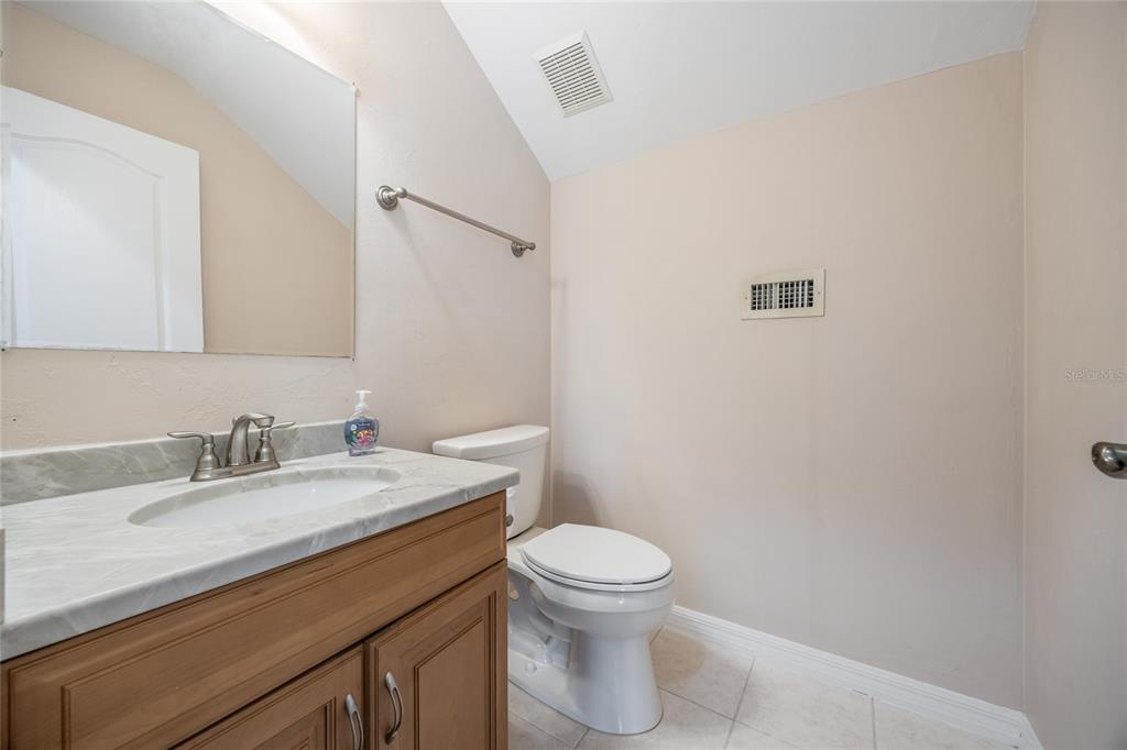7146 Southwest 35th Avenue Gainesville, FL 32608 - Photo 63 of 83 a bathroom with a sink a toilet and mirror