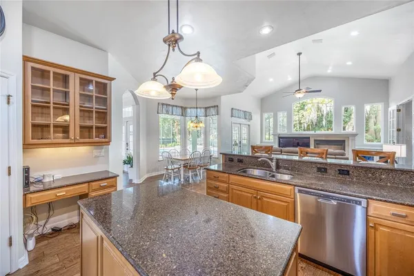 a kitchen with granite countertop a sink and a wooden floor