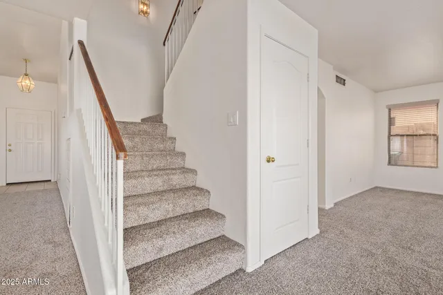 a view of entryway with wooden floor and stairs