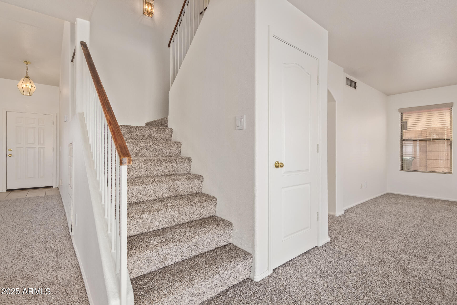 2432 West Blue Sky Drive Phoenix, AZ 85085 - Photo 11 of 40 a view of entryway with wooden floor and stairs