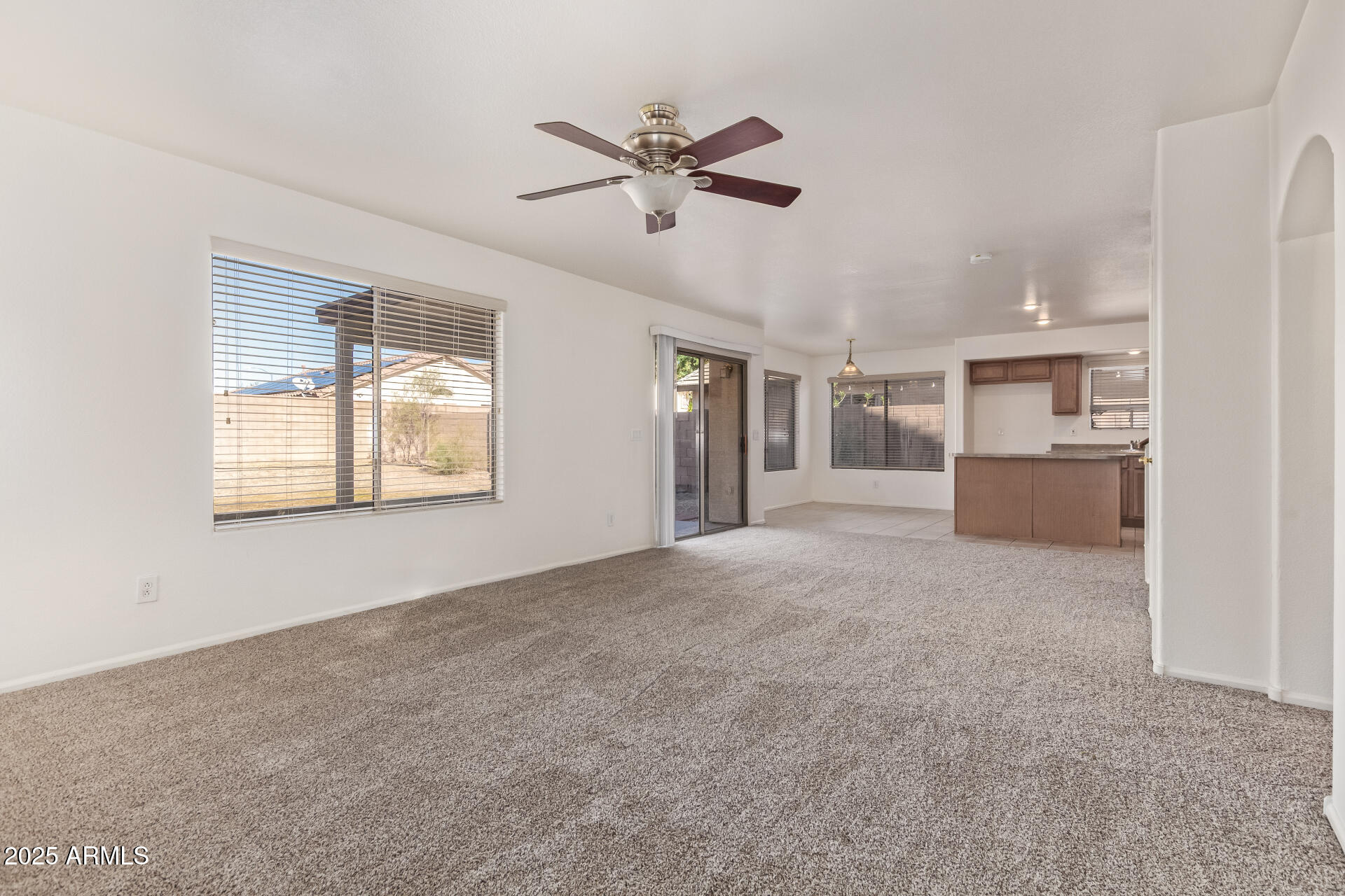 2432 West Blue Sky Drive Phoenix, AZ 85085 - Photo 14 of 40 a view of a livingroom with a ceiling fan and windows