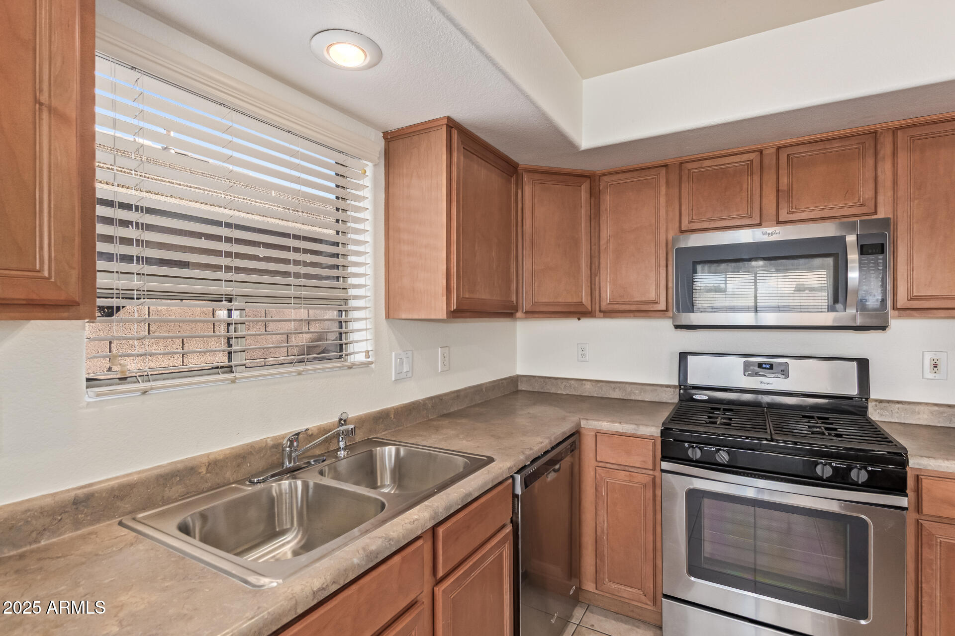 2432 West Blue Sky Drive Phoenix, AZ 85085 - Photo 18 of 40 a kitchen with a sink stove top oven and cabinets