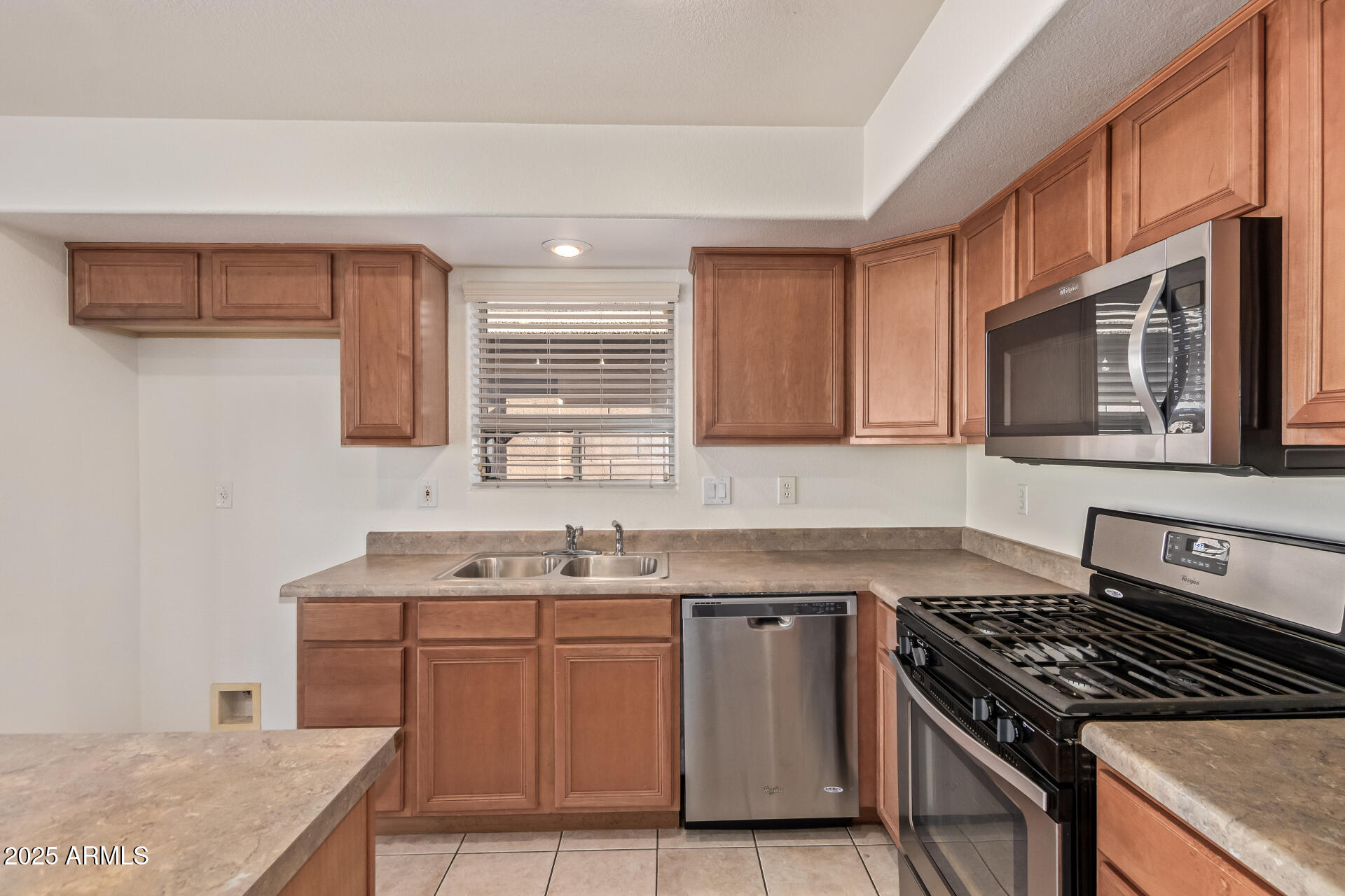 2432 West Blue Sky Drive Phoenix, AZ 85085 - Photo 19 of 40 a kitchen with stainless steel appliances granite countertop a sink stove and cabinets