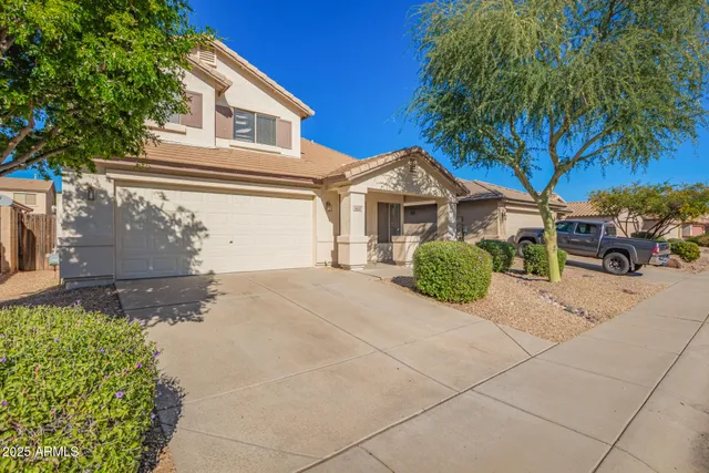 a view of a house with a yard and plants