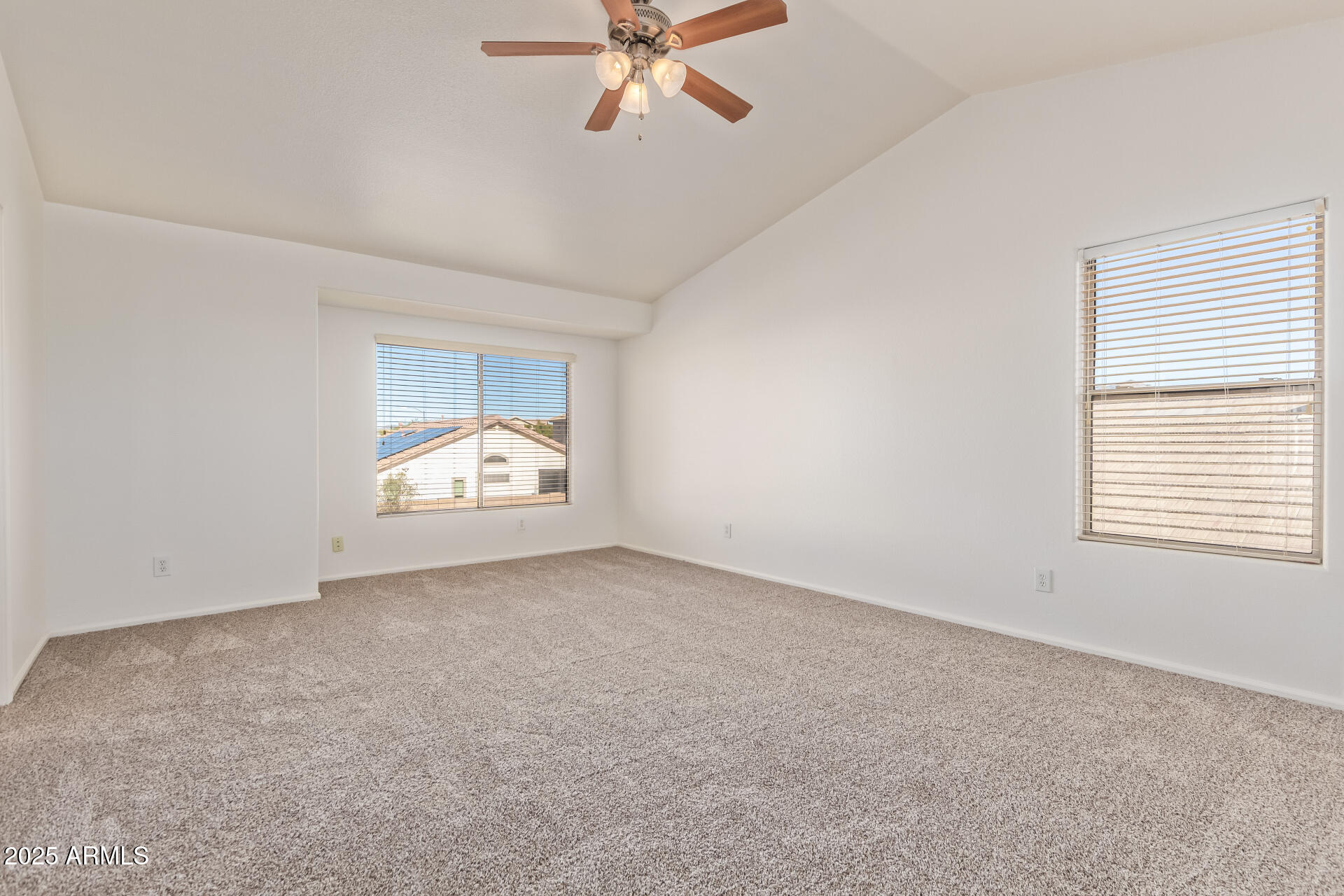 2432 West Blue Sky Drive Phoenix, AZ 85085 - Photo 22 of 40 an empty room with a window and a ceiling fan