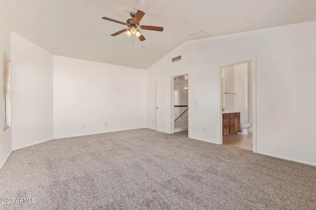 an empty room with closet and a ceiling fan