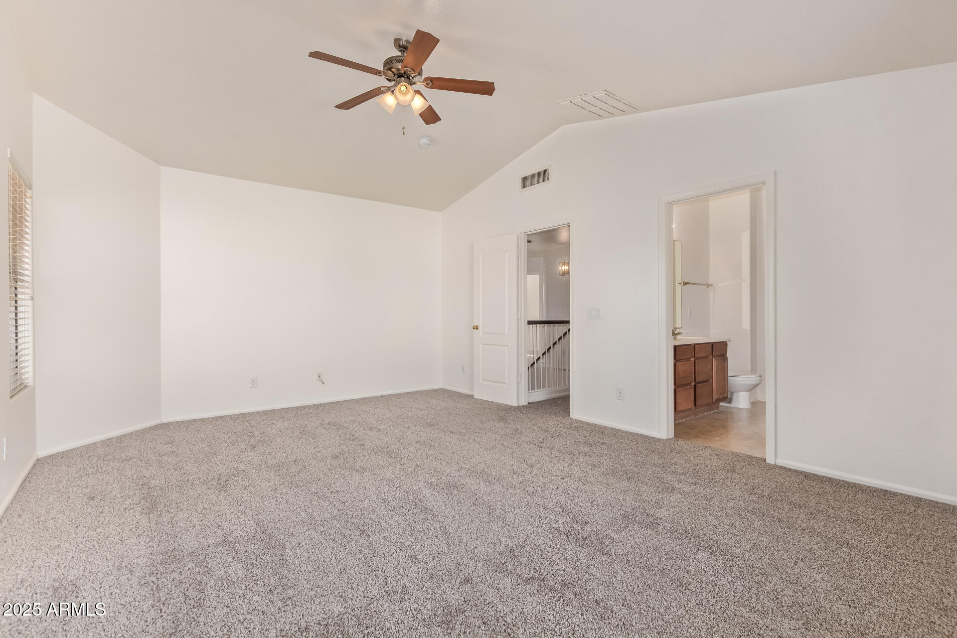 2432 West Blue Sky Drive Phoenix, AZ 85085 - Photo 24 of 40 an empty room with closet and a ceiling fan