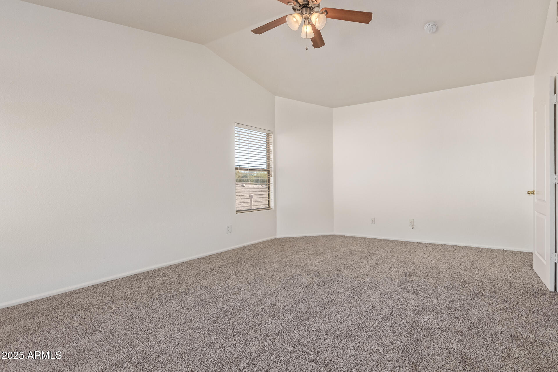 2432 West Blue Sky Drive Phoenix, AZ 85085 - Photo 25 of 40 an empty room with a chandelier fan