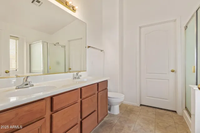 a bathroom with a granite countertop sink a toilet and a mirror