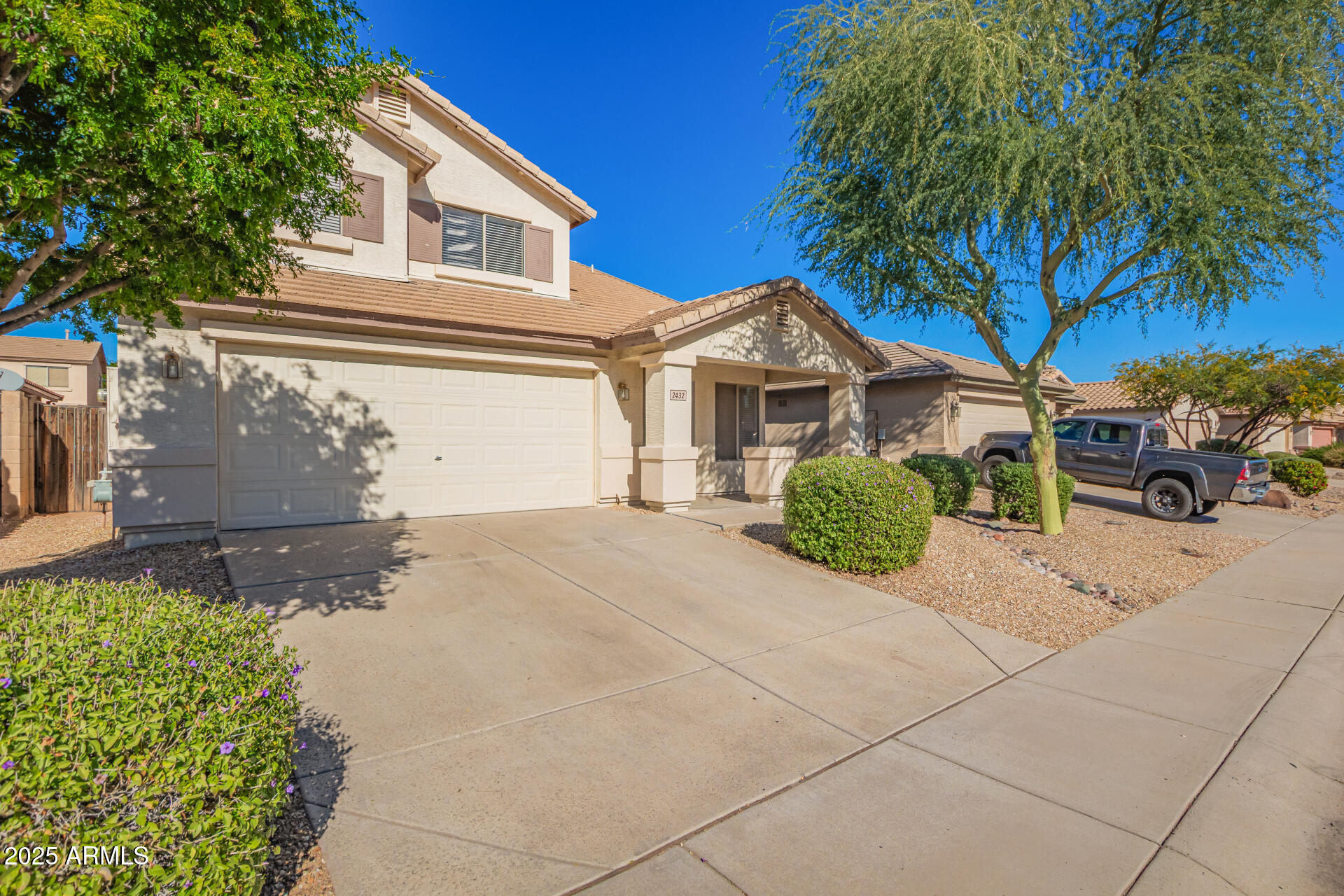 2432 West Blue Sky Drive Phoenix, AZ 85085 - Photo 3 of 40 a view of a house with a yard and plants
