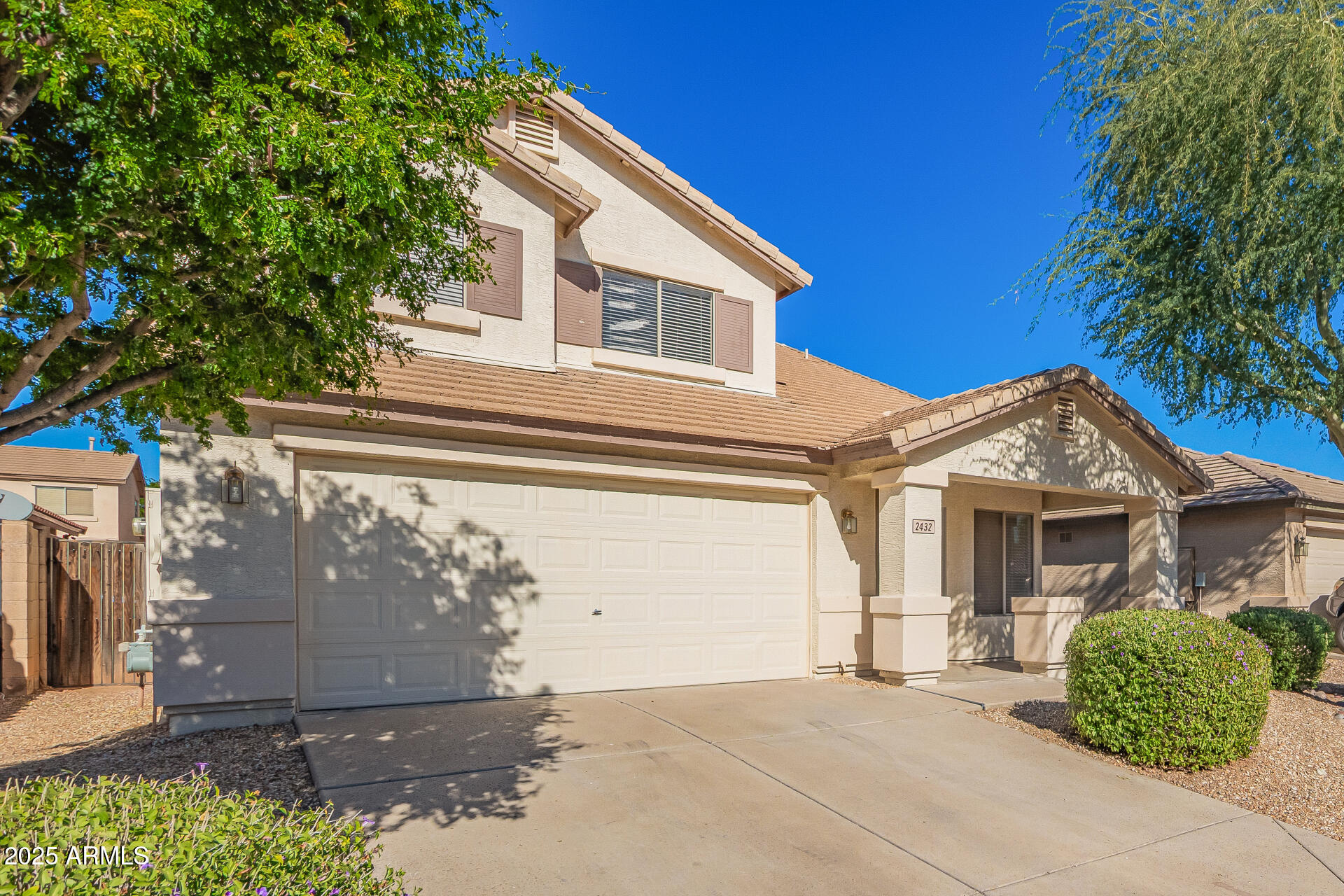 2432 West Blue Sky Drive Phoenix, AZ 85085 - Photo 4 of 40 a view of a house with a small yard plants and a large tree