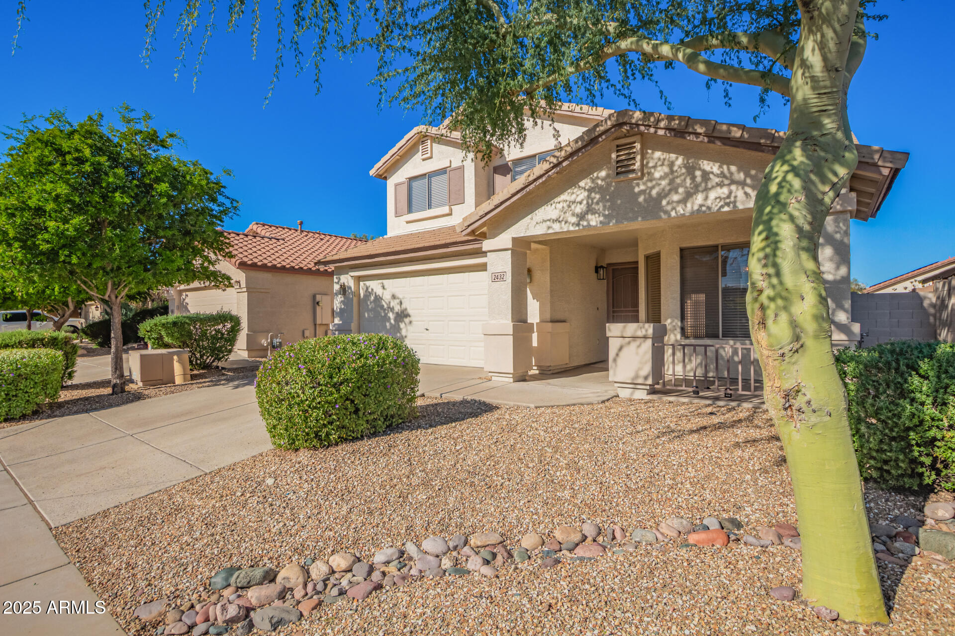 2432 West Blue Sky Drive Phoenix, AZ 85085 - Photo 5 of 40 a view of a house with a yard and potted plants