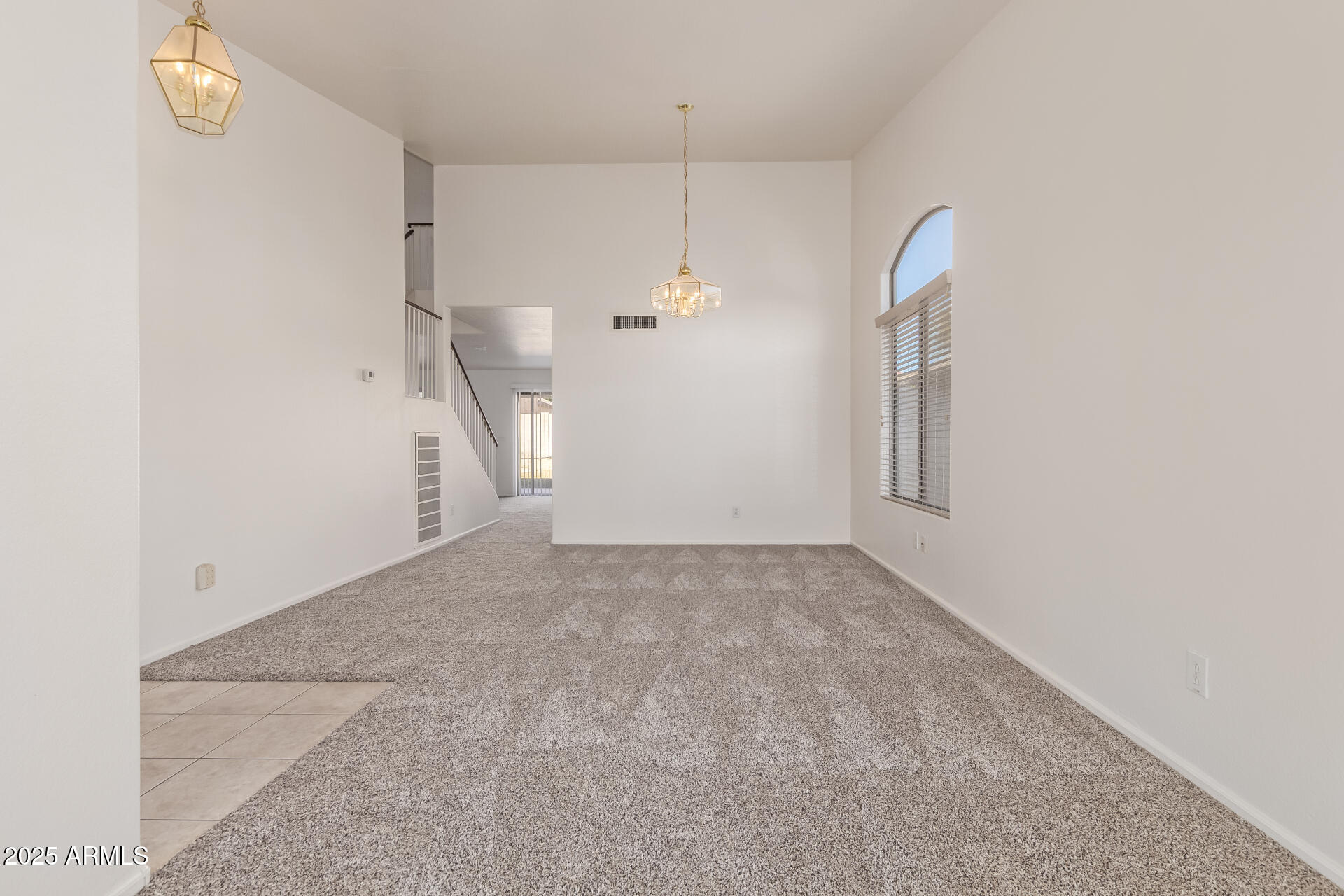 2432 West Blue Sky Drive Phoenix, AZ 85085 - Photo 9 of 40 a view of a room with stairs and a chandelier fan