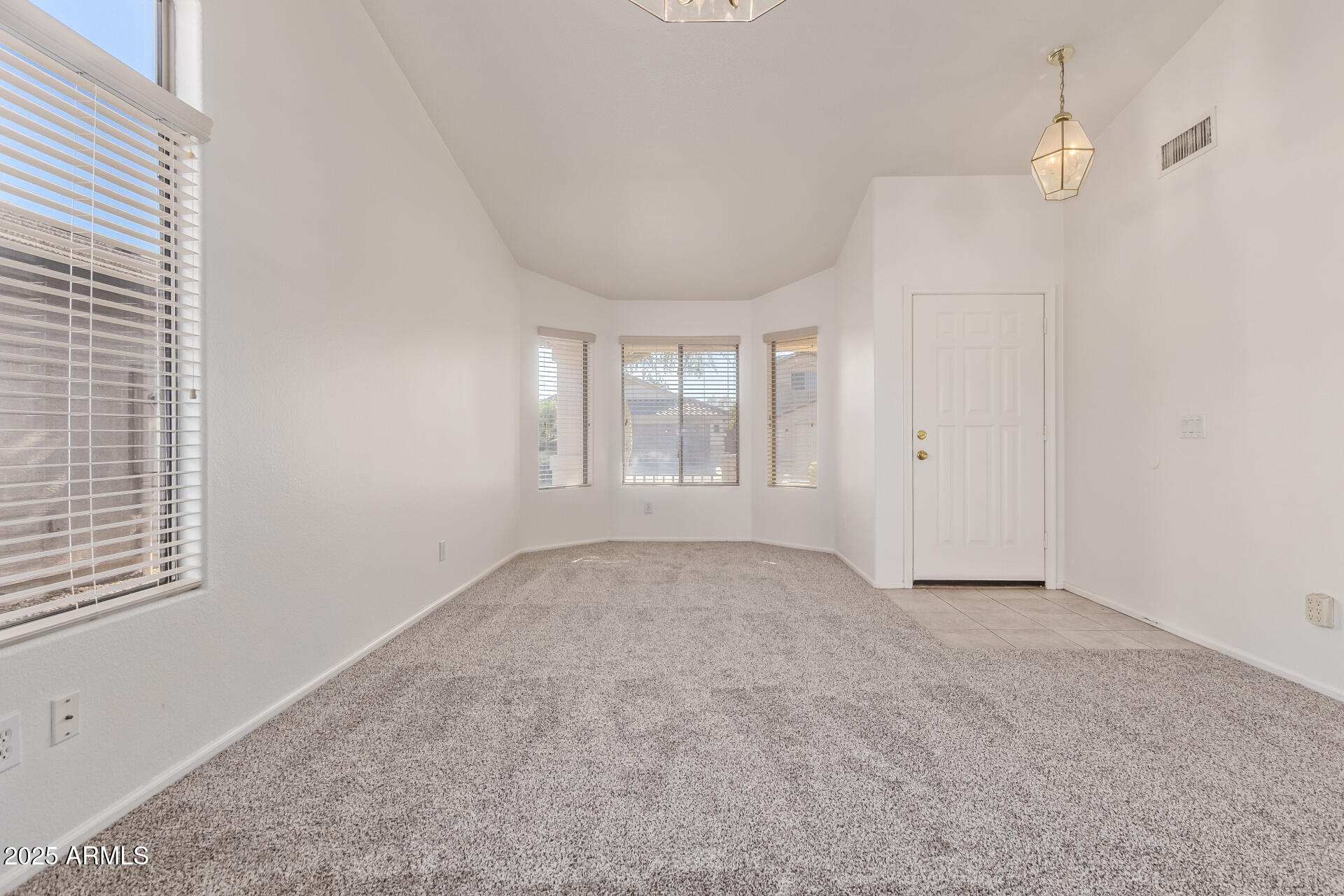 2432 West Blue Sky Drive Phoenix, AZ 85085 - Photo 10 of 40 an empty room with windows