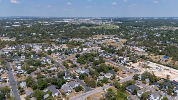 an aerial view of residential houses with city view