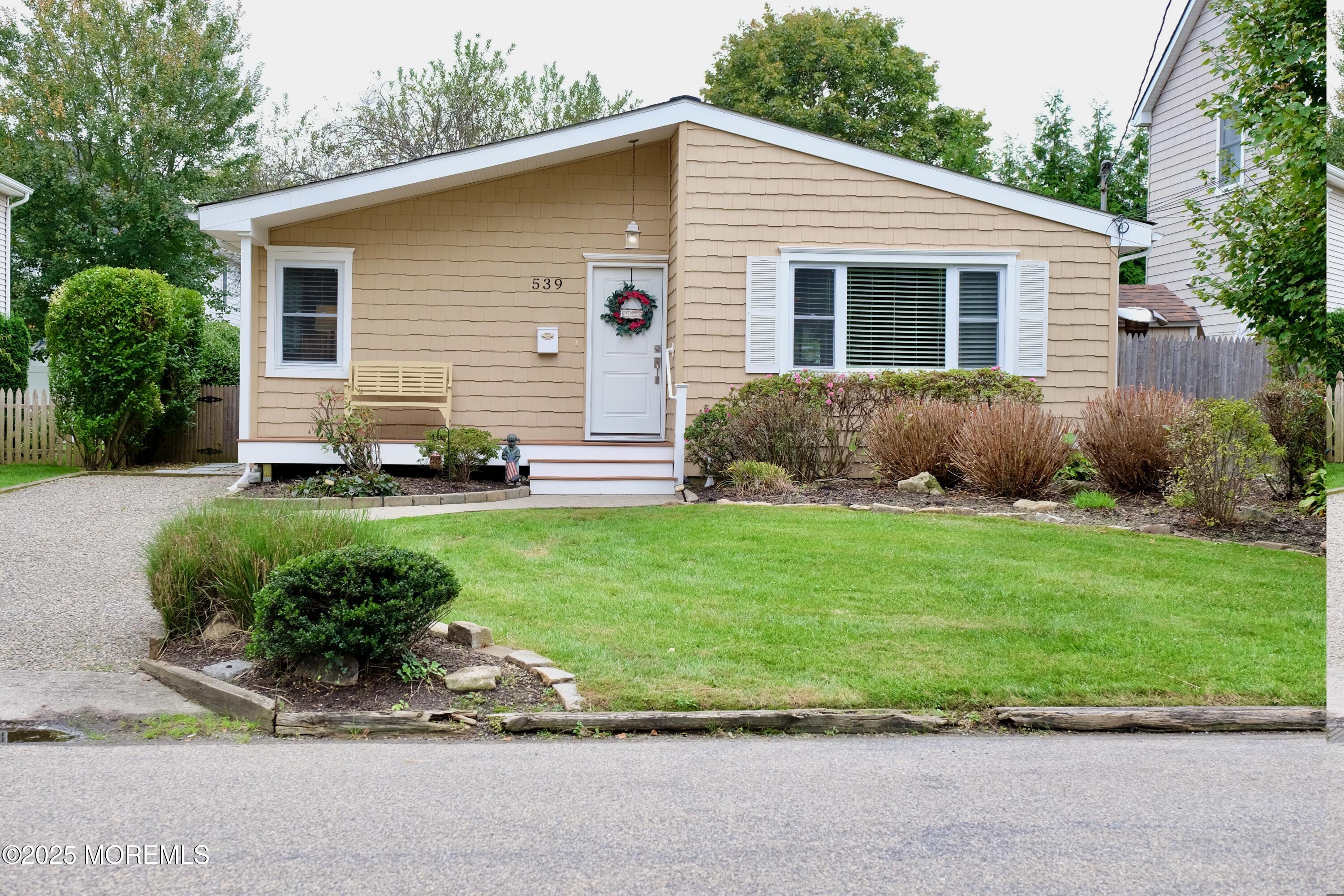 a front view of a house with a garden