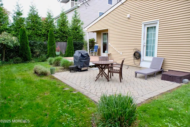 a view of backyard with seating space and trees
