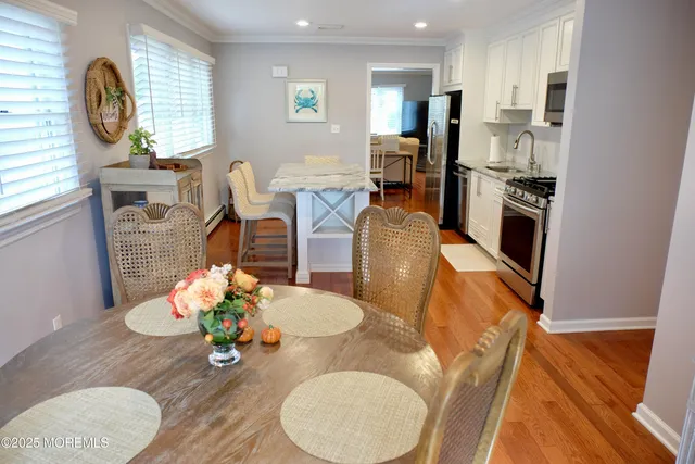 a living room with furniture dining table wooden floor and a fireplace