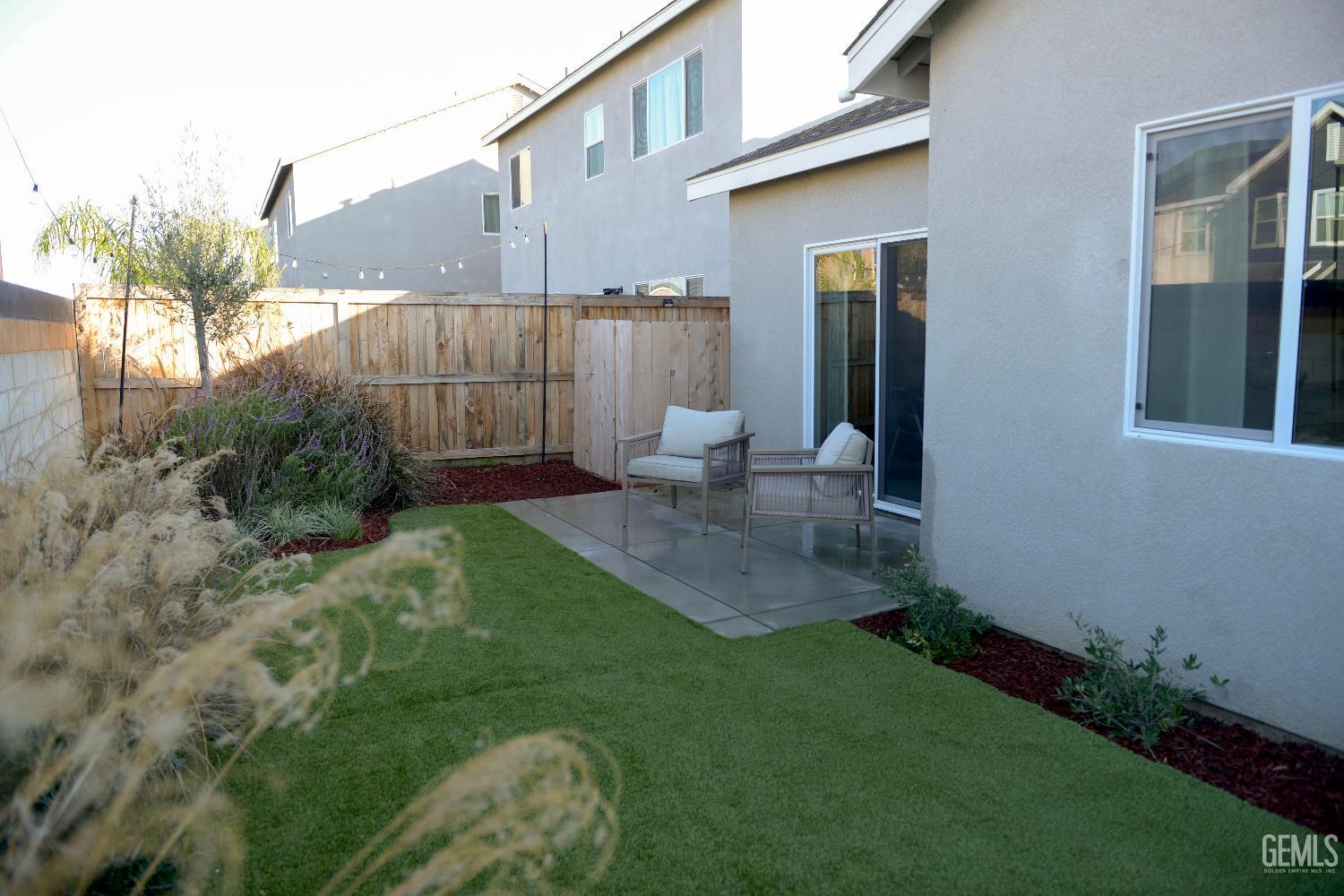 Undisclosed Address Shafter, CA 93263 - Photo 22 of 23 a view of a backyard with plants and a patio