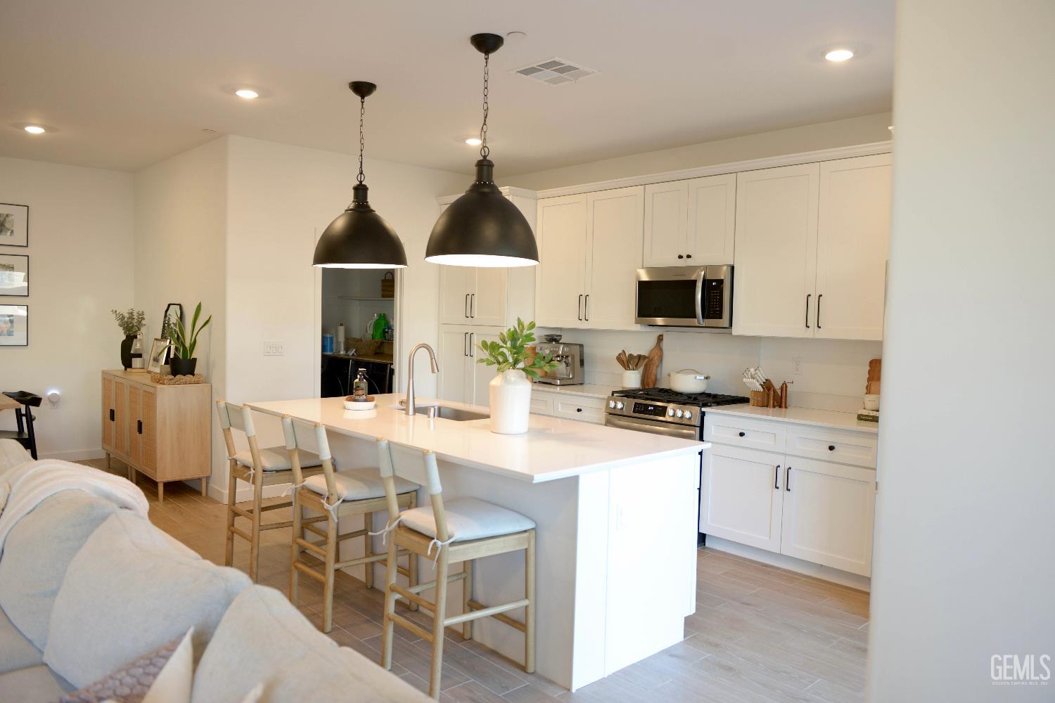 Undisclosed Address Shafter, CA 93263 - Photo 5 of 23 a kitchen with stainless steel appliances granite countertop a sink a stove a refrigerator cabinets and chairs