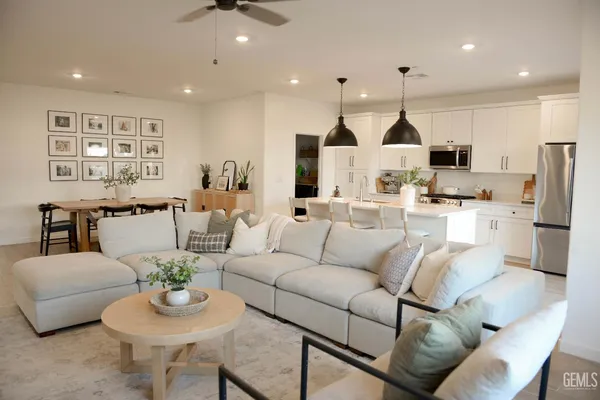a living room with furniture kitchen and a table