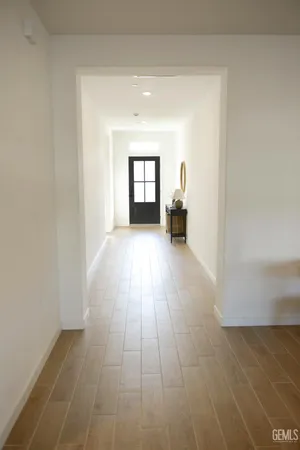 a view of a room with wooden floor and a window