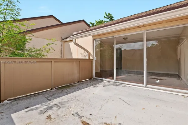 a view of backyard with a large tree