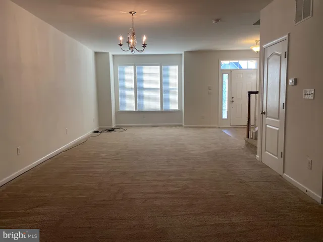 a view of an empty room with a mirror