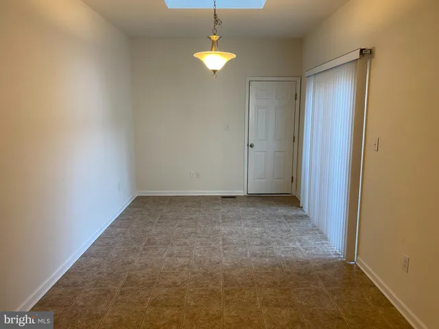 a view of a room with a ceiling fan and a window
