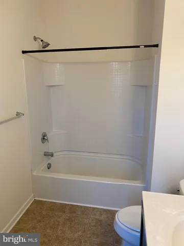 a bathroom with a shower and a toilet