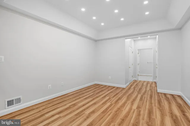 a view of a room with wooden floor and closet