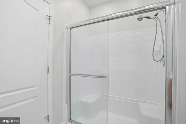 a bathroom with a glass shower door