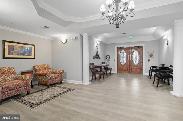 a living room with furniture and a chandelier