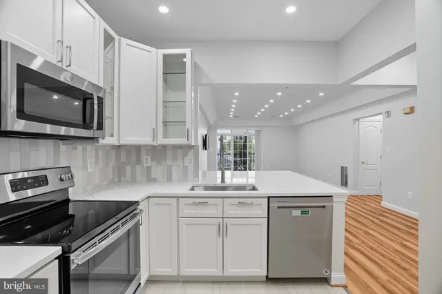 a kitchen with a sink cabinets and microwave