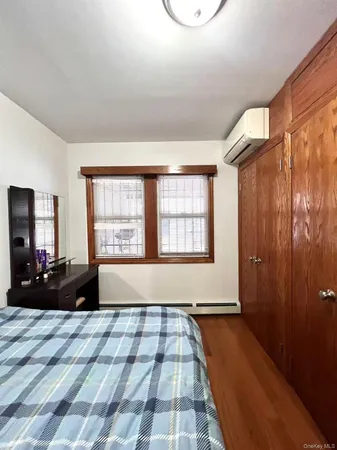 a view of a bedroom with wooden floor