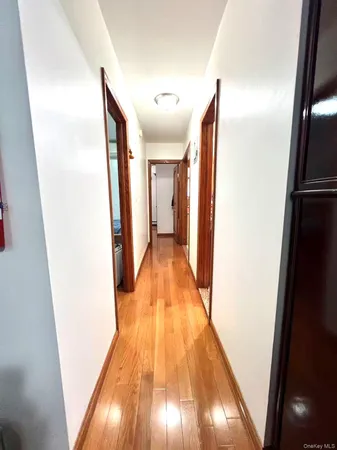 a view of a hallway with wooden floor
