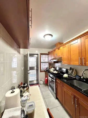 a kitchen with stainless steel appliances granite countertop a sink stove and cabinets