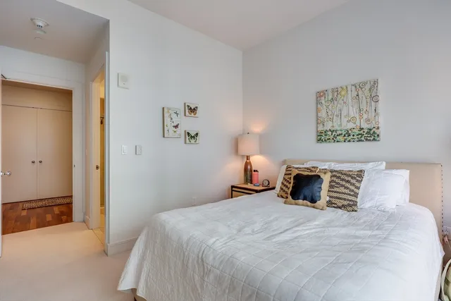 a bedroom with a bed and a lamp