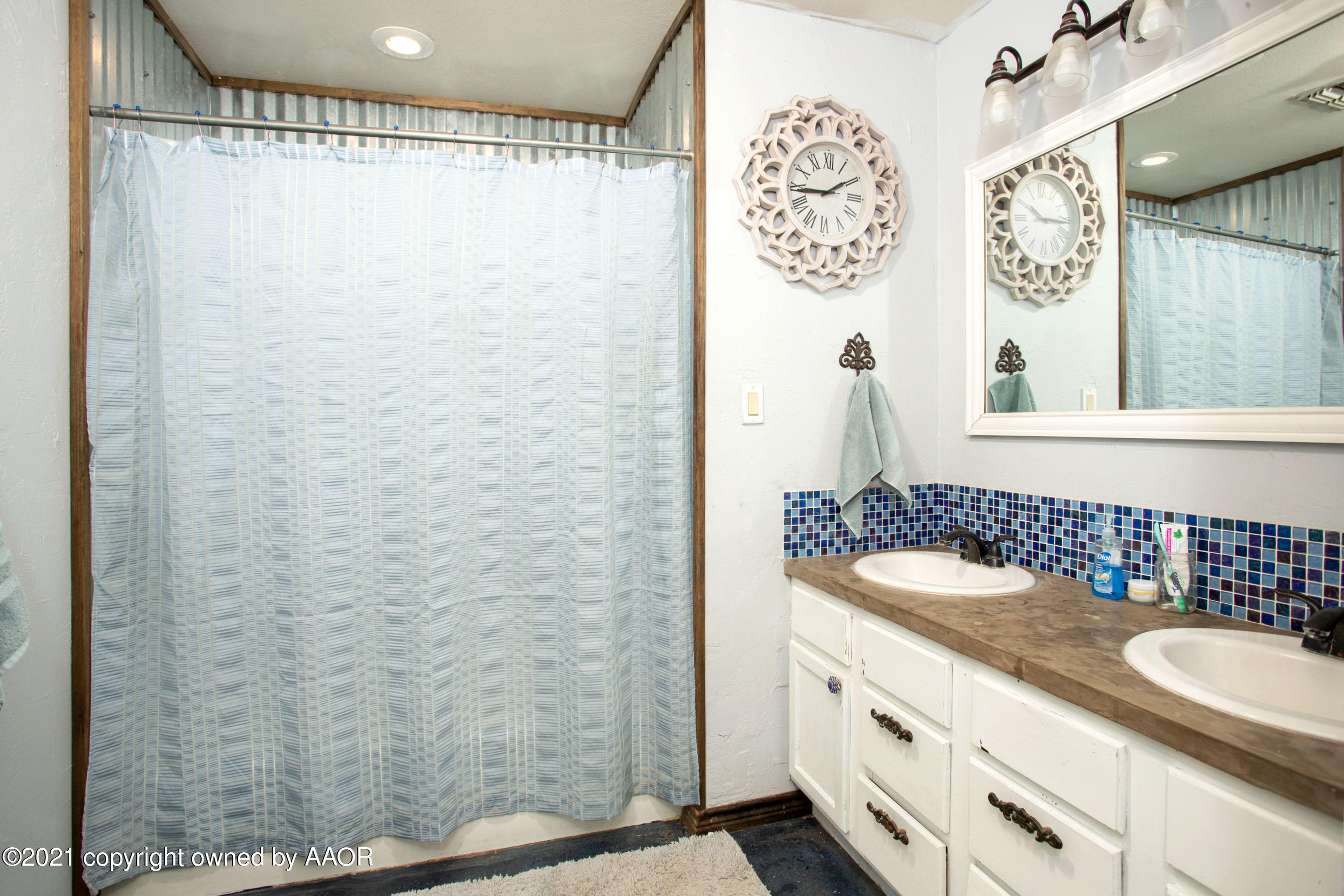 235 Cliffside Drive Amarillo, TX 79118 - Photo 12 of 39 a bathroom with a sink and a mirror