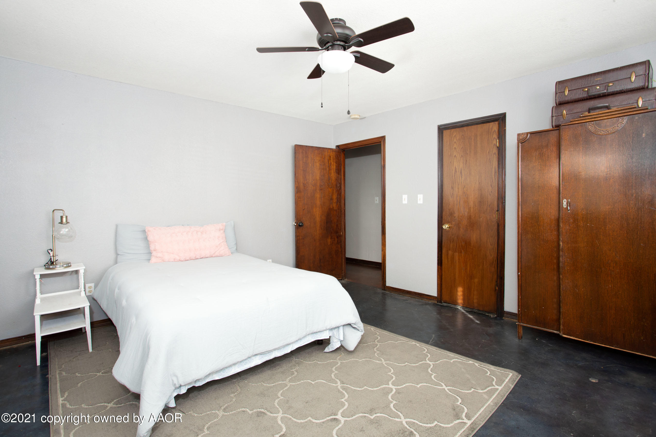 235 Cliffside Drive Amarillo, TX 79118 - Photo 15 of 39 a bedroom with a bed and a chandelier