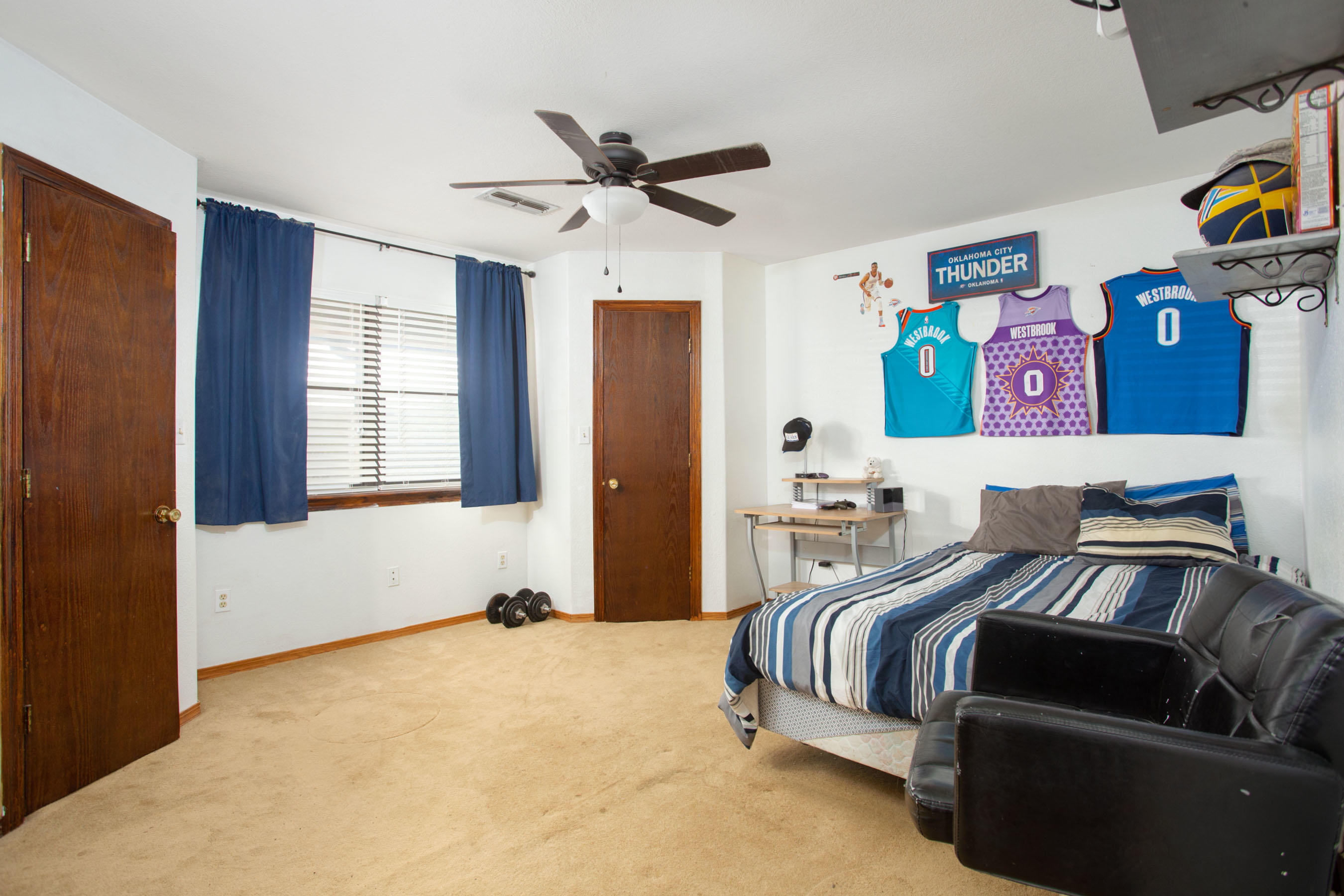 235 Cliffside Drive Amarillo, TX 79118 - Photo 17 of 39 a bedroom with a bed and wooden floor