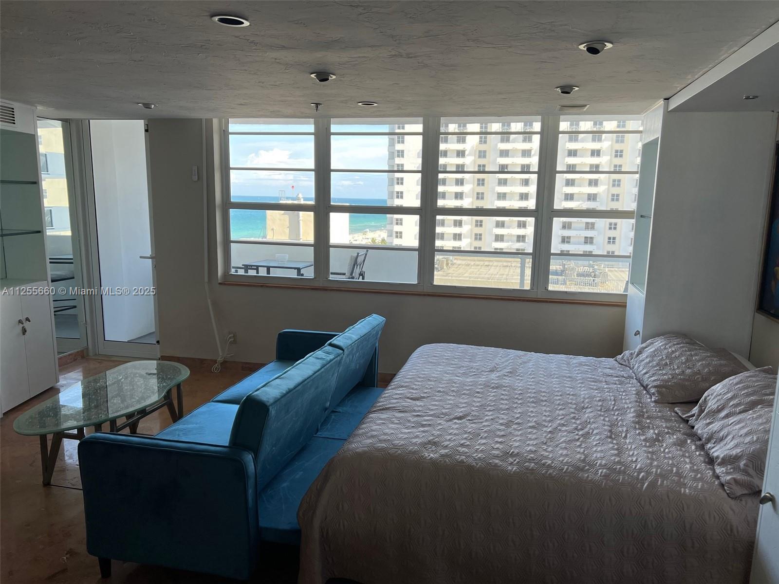 100 Lincoln Road, Unit 1228 Miami Beach, FL 33139 - Photo 11 of 70 a bed sitting in a bedroom next to a window