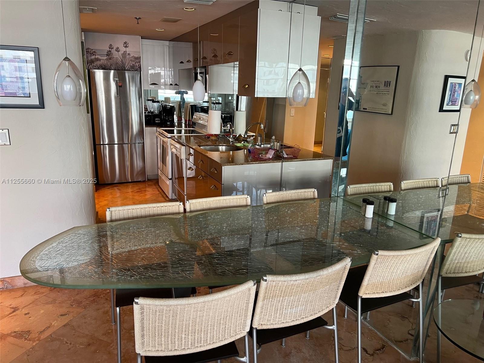 100 Lincoln Road, Unit 1228 Miami Beach, FL 33139 - Photo 15 of 70 a kitchen with stainless steel appliances granite countertop a sink refrigerator and microwave