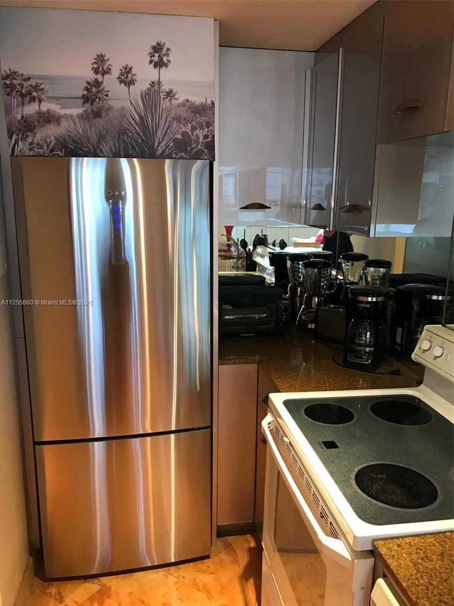 100 Lincoln Road, Unit 1228 Miami Beach, FL 33139 - Photo 20 of 70 a kitchen with stainless steel appliances a refrigerator a sink a stove and a refrigerator