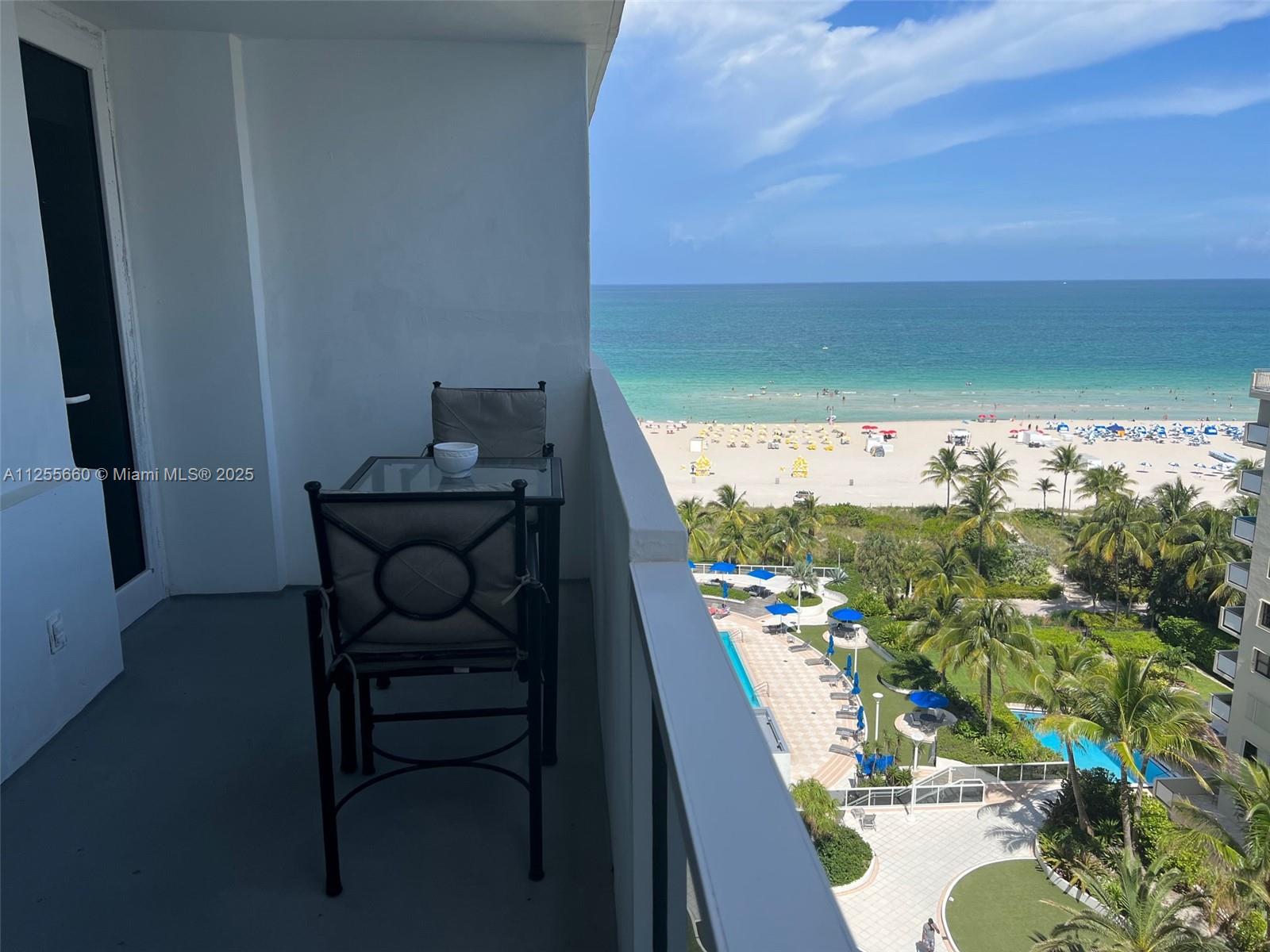 100 Lincoln Road, Unit 1228 Miami Beach, FL 33139 - Photo 2 of 70 a view of a balcony with wooden floor and outdoor seating