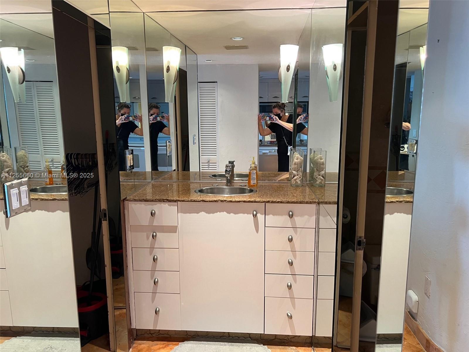 100 Lincoln Road, Unit 1228 Miami Beach, FL 33139 - Photo 24 of 70 a bathroom with a sink vanity and a mirror