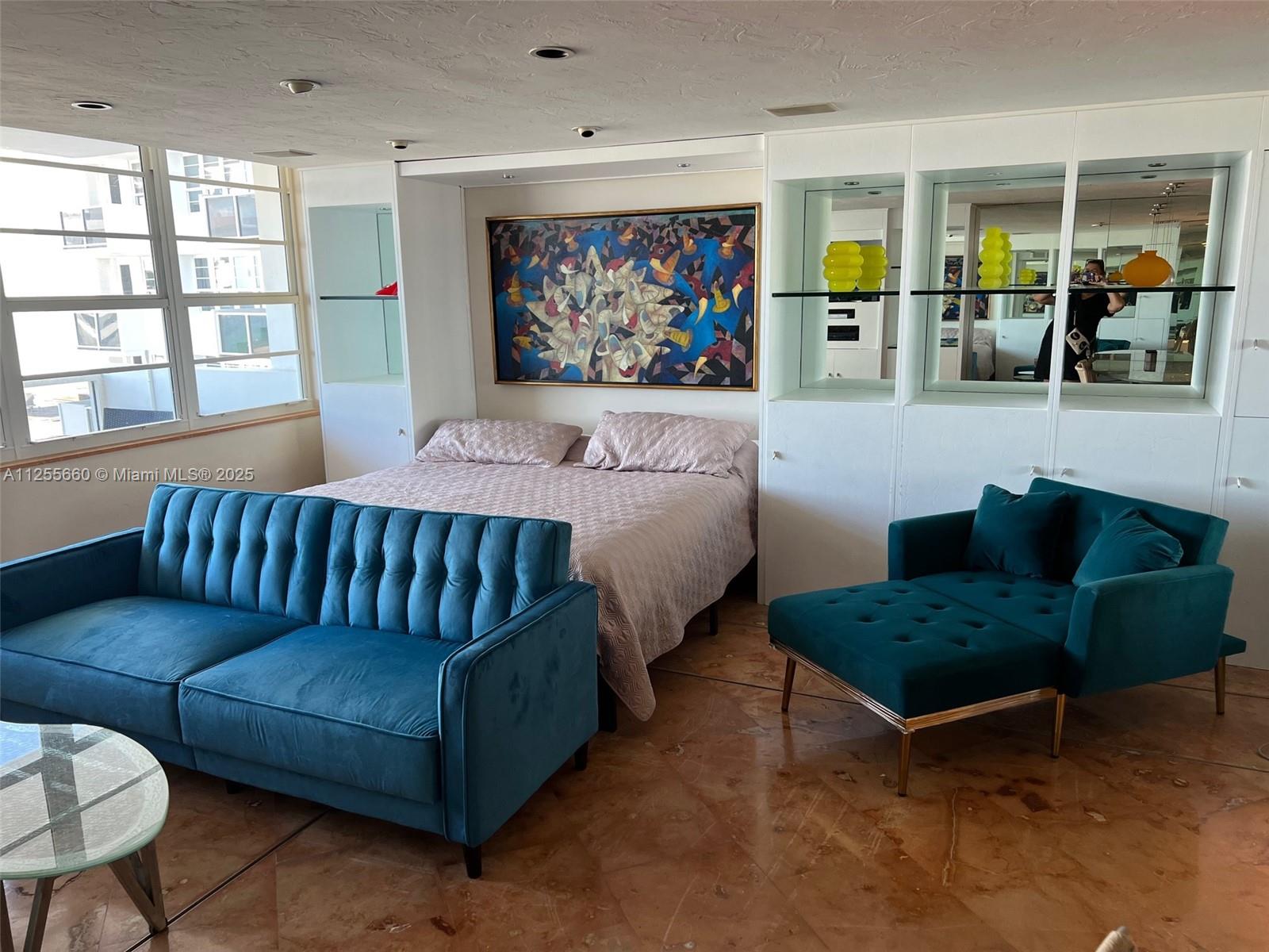 100 Lincoln Road, Unit 1228 Miami Beach, FL 33139 - Photo 9 of 70 a living room with furniture a rug and wall paintings