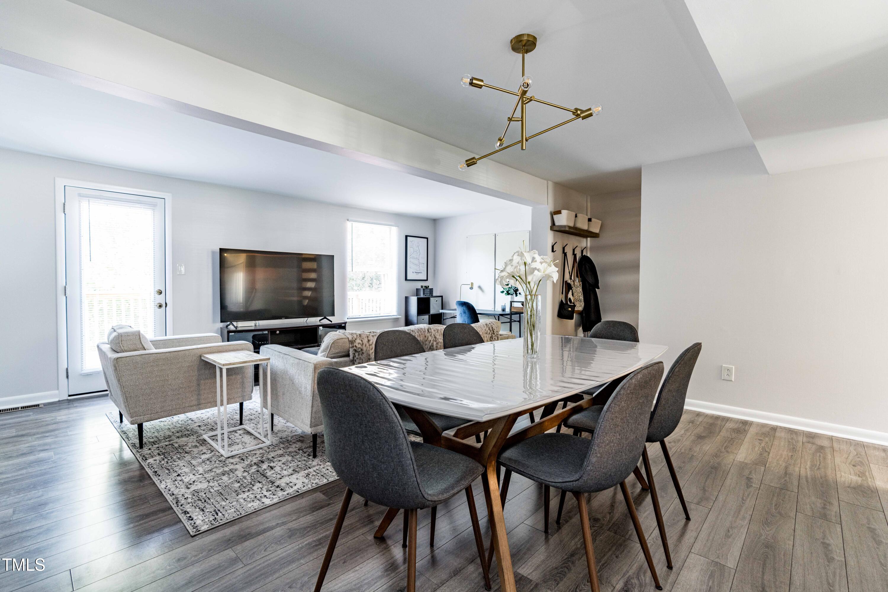1708 Ithaca Lane, Unit A Raleigh, NC 27606 - Photo 13 of 30 a view of a dining room with furniture window and wooden floor