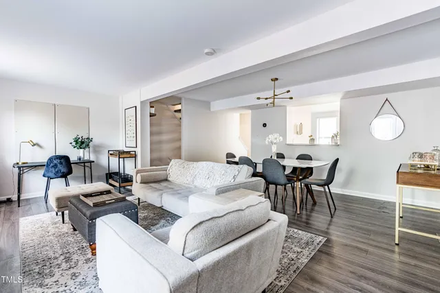 a living room with furniture a rug and a chandelier